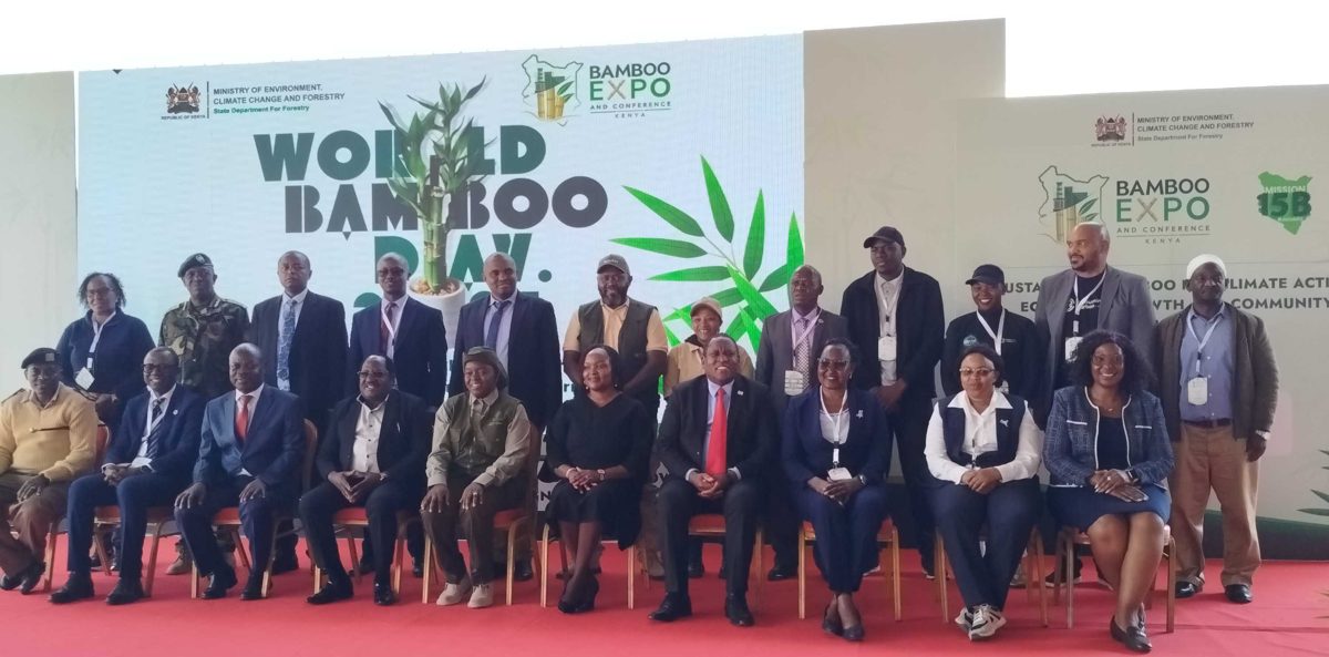 Officials, exhibitors and partners gathered on stage for the World Bamboo Day 2026 group photo at Meru University.