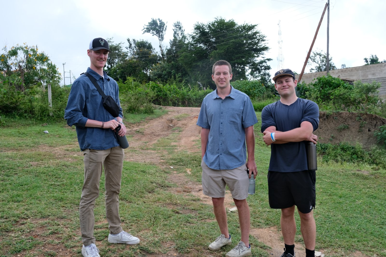 UVA interns Samuel, Jake, and Camper on a dirt path in Wamunyu.