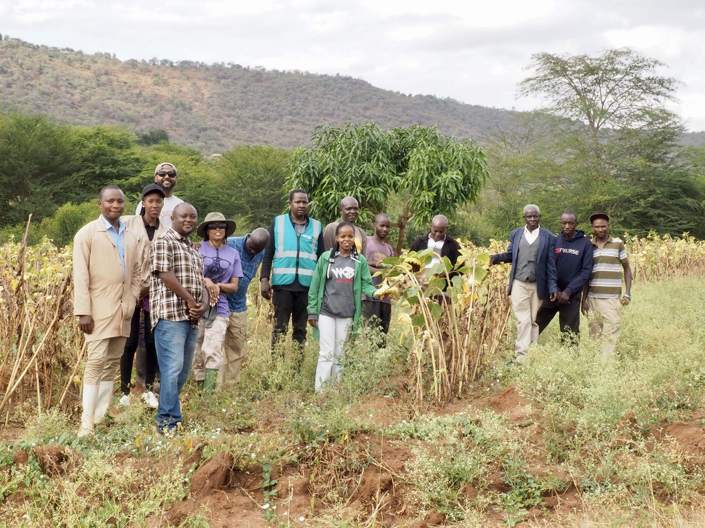 Wamunyu — the cooperative standing with biochar piles in the field